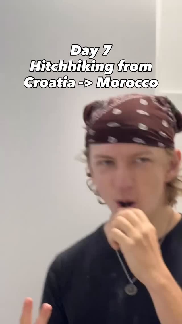 Mid-sentence in a bare white room, a patterned bandana tied over his hair.